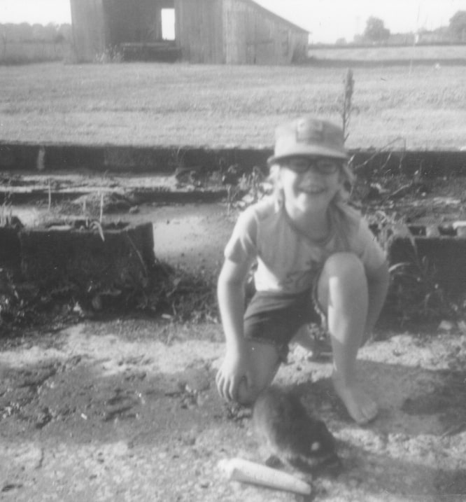 John Sutton as boy with pet raccoon